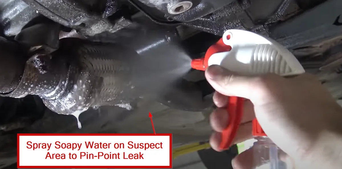 Applying Soapy Water To Reveal Exhaust Leaks 